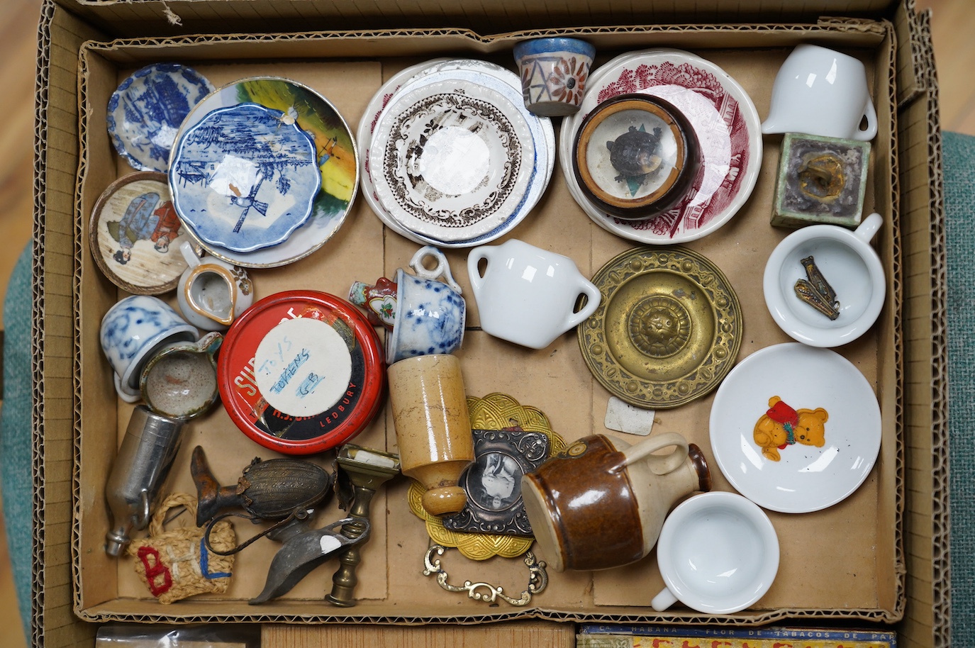 A large collection of various collectables and oddities including a Zulu bone snuff spoon incised with a locomotive and carriages, charms, miniature ceramics etc. Condition - poor to fair.